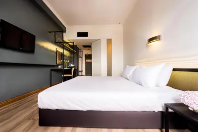 a hotel room with a bed and a tv at Hotel Sentral Pudu @ City Centre / Bukit Bintang in Kuala Lumpur