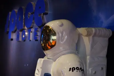 a plastic astronaut figurine in front of a sign at Space Hotel @ Chinatown Kuala Lumpur in Kuala Lumpur