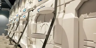 a row of white toilets on a wall at Space Hotel @ Chinatown Kuala Lumpur in Kuala Lumpur