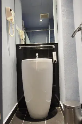 a bathroom with a white toilet in a stall at Space Hotel @ Chinatown Kuala Lumpur in Kuala Lumpur
