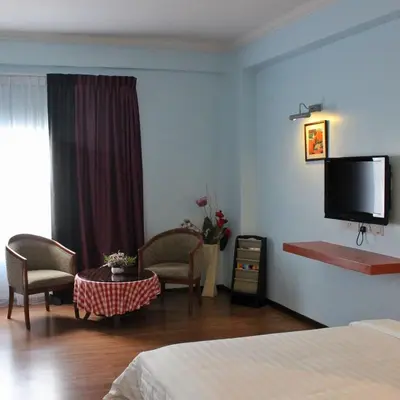 a bedroom with a bed and a flat screen tv at Hotel Maluri in Kuala Lumpur