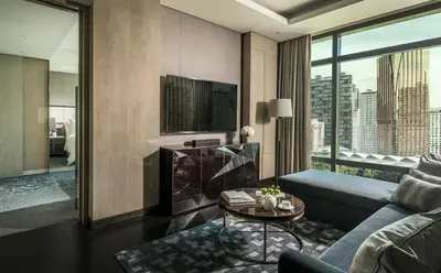 a living room with a couch and a table at Four Seasons Hotel Kuala Lumpur in Kuala Lumpur
