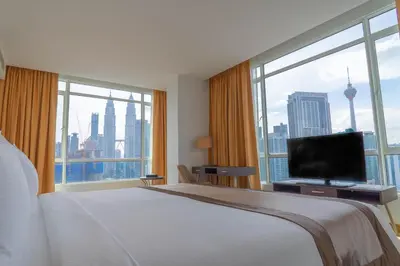 a hotel room with a bed and a large window at Tamu Hotel & Suites Kuala Lumpur in Kuala Lumpur