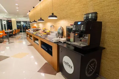 a coffee station in a restaurant with a coffee maker at Tamu Hotel & Suites Kuala Lumpur in Kuala Lumpur