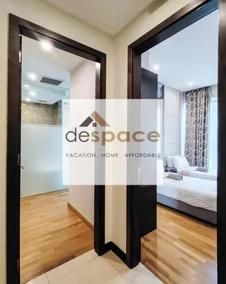 a glass door in a room with a living room at Dorsett Bukit Bintang Residence by De Space in Kuala Lumpur