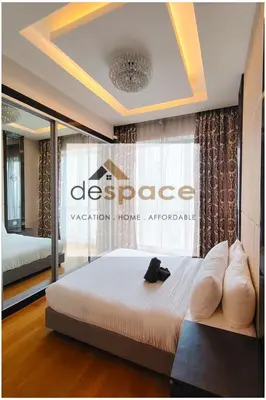 a bedroom with a bed with a black shoe on it at Dorsett Bukit Bintang Residence by De Space in Kuala Lumpur