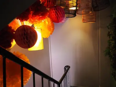 a hallway with colorful paper lanterns on a wall at Leo Backpackers @ Central Market in Kuala Lumpur