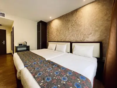 a bedroom with a large white bed in a room at My Hotel @ Bukit Bintang in Kuala Lumpur