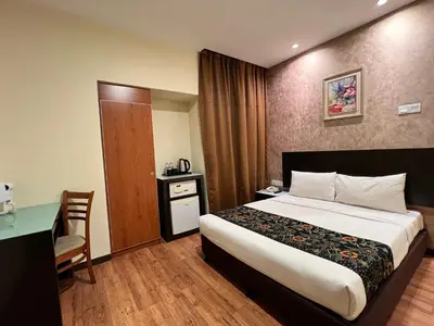 a hotel room with a bed and a table and a desk at My Hotel @ Bukit Bintang in Kuala Lumpur