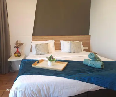 a hotel room with a bed with a tray on it at Holiday Heaven in Kuala Lumpur