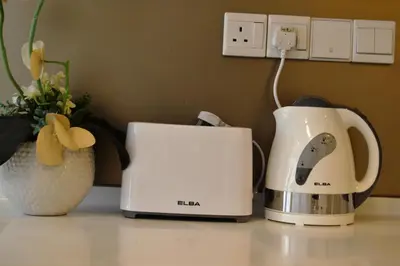 a coffee maker and a toaster on a counter at Holiday Heaven in Kuala Lumpur