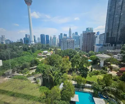 a view of the singapore city skyline with a pool at Holiday Heaven in Kuala Lumpur