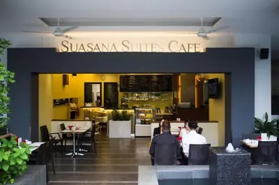 a restaurant with people sitting at tables in front of it at Holiday Heaven in Kuala Lumpur