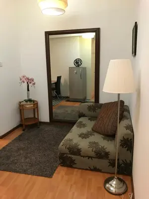 a living room with a couch and a mirror at Parkview KLCC in Kuala Lumpur