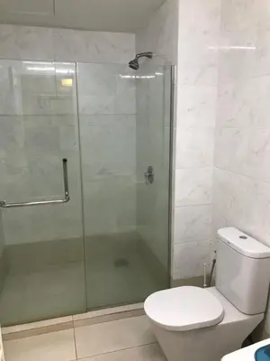 a bathroom with a toilet and a glass shower at Parkview KLCC in Kuala Lumpur