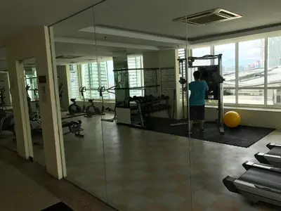 a man in a gym with a view of the city at Parkview KLCC in Kuala Lumpur