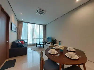 a living room with a table and a couch at Inspired Homes @ KLCC Soho Suite in Kuala Lumpur