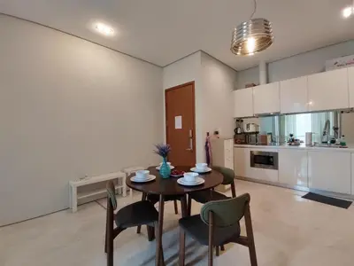 a kitchen and dining room with a table and chairs at Inspired Homes @ KLCC Soho Suite in Kuala Lumpur