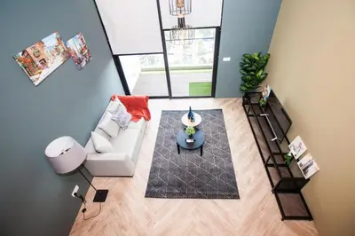an overhead view of a living room with a couch and a table at The Establishment KL Sentral Bangsar by Plush in Kuala Lumpur