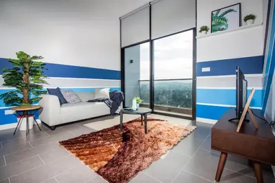 a living room with a couch and a television at The Establishment KL Sentral Bangsar by Plush in Kuala Lumpur