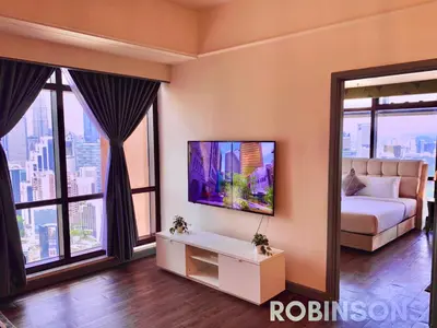 a living room with a couch and large windows at Robinsons at Times Square Kuala Lumpur in Kuala Lumpur