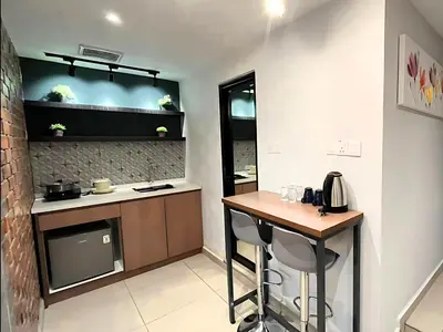 a kitchen with a counter and a table in a room at Seeds Hotel Ampang Point in Kuala Lumpur