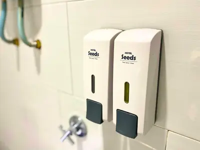 two rolls of toilet paper on the wall of a bathroom at Seeds Hotel Ampang Point in Kuala Lumpur