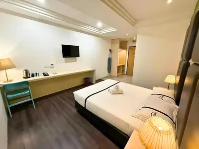 a hotel room with a bed and a desk at Seeds Hotel Ampang Point in Kuala Lumpur
