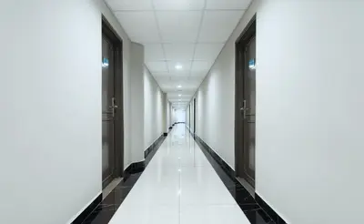 an empty corridor in a building with white walls and floors at Fahrenheit Suites Bukit Bintang, Kuala Lumpur in Kuala Lumpur