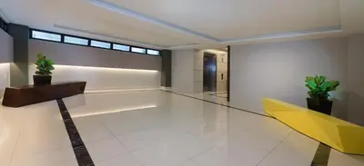 a lobby with a yellow table and potted plants at Fahrenheit Suites Bukit Bintang, Kuala Lumpur in Kuala Lumpur