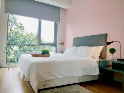 a bedroom with a large bed with a large window at The Signature Serviced Suites Kuala Lumpur in Kuala Lumpur