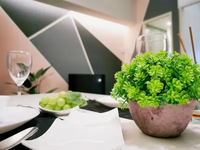 a table with a bowl of grapes and a plant at The Signature Serviced Suites Kuala Lumpur in Kuala Lumpur
