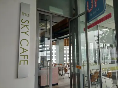an entrance to a building with tables and chairs at The Signature Serviced Suites Kuala Lumpur in Kuala Lumpur