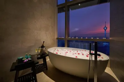 a bath tub in a bathroom with a view of a city at Banyan Tree Kuala Lumpur in Kuala Lumpur