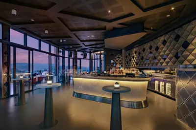 a restaurant with a bar with a view at Banyan Tree Kuala Lumpur in Kuala Lumpur