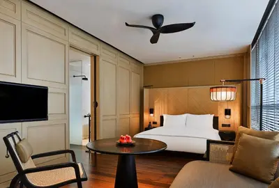 a hotel room with a bed and a table at The RuMa Hotel and Residences in Kuala Lumpur