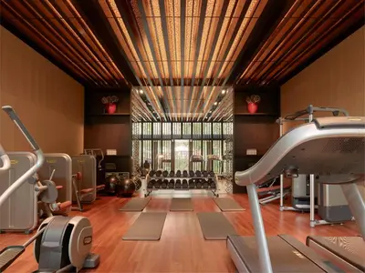 a gym with exercise equipment and a large window at The RuMa Hotel and Residences in Kuala Lumpur