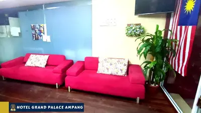two red couches in a room with a flag at Hotel Grand Palace Ampang in Ampang