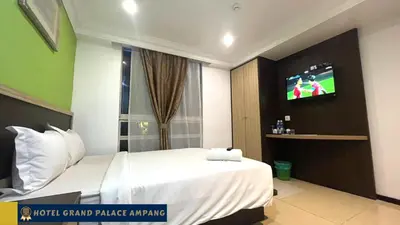 a hotel room with a bed and a flat screen tv at Hotel Grand Palace Ampang in Ampang