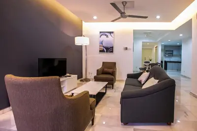 a living room with two couches and a tv at The Forum Condominium by LaFabrica in Kuala Lumpur