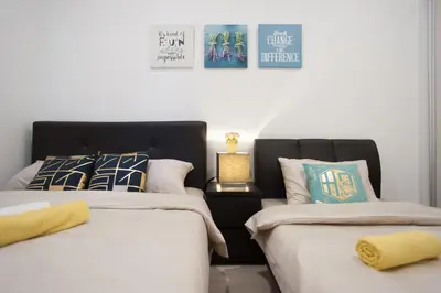two beds sitting next to each other in a bedroom at Mcity Jalan Ampang in Kuala Lumpur