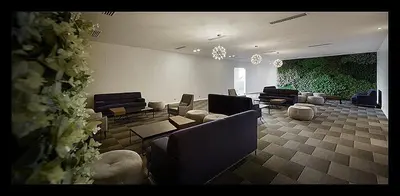 a large living room with couches and chairs and a large green wall at Mcity Jalan Ampang in Kuala Lumpur