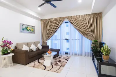 a living room with a couch and a large window at Mcity Jalan Ampang in Kuala Lumpur