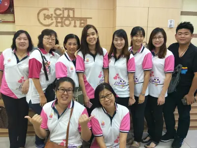 a group of women in pink and white shirts posing for a picture at CITI HOTEL @ KL SENTRAL in Kuala Lumpur