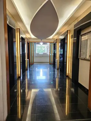 an empty hallway in a building with a large window at Holiday Paradise in Kuala Lumpur