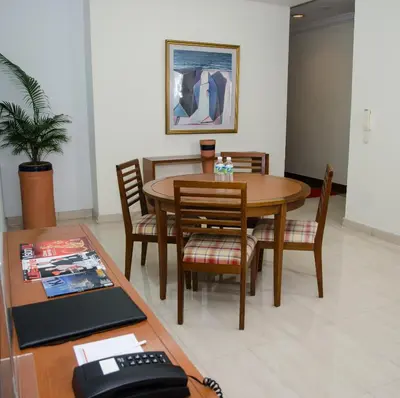 a dining room with a table with chairs and a telephone at The Maple Suite in Kuala Lumpur