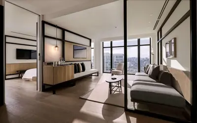 a bedroom with a bed and a desk with a television at Alila Bangsar Kuala Lumpur in Kuala Lumpur