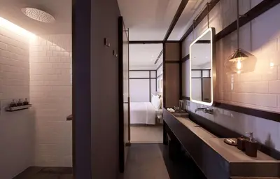 a bathroom with two sinks and a large mirror at Alila Bangsar Kuala Lumpur in Kuala Lumpur