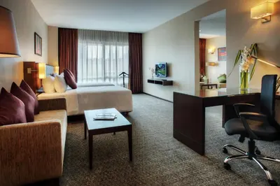 a hotel room with a bed and a desk at Furama Bukit Bintang, Kuala Lumpur in Kuala Lumpur