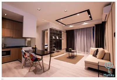 a kitchen and living room with a table and a couch at Expressionz Professional Suites by MyKey in Kuala Lumpur